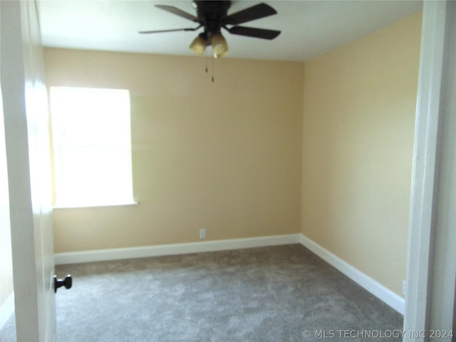 carpeted empty room featuring ceiling fan