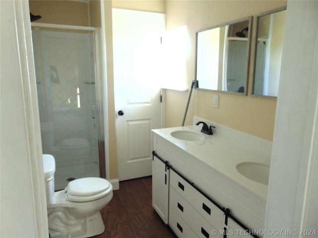 bathroom with a shower, wood-type flooring, vanity, and toilet