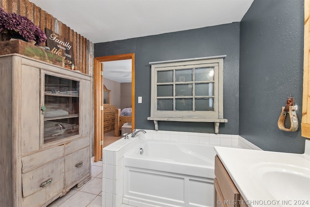 bathroom featuring vanity, tile patterned flooring, and a bathtub