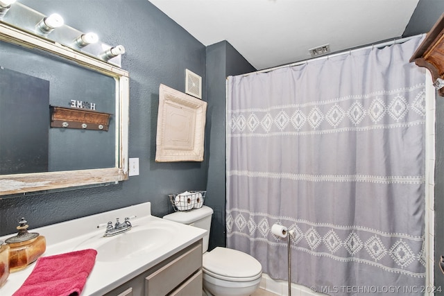 bathroom with toilet, vanity, and a shower with shower curtain