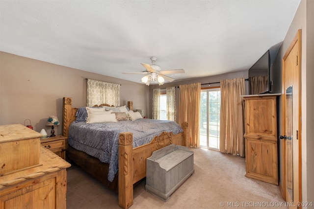 bedroom with access to exterior, light carpet, and ceiling fan