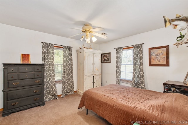 bedroom featuring ceiling fan and light carpet