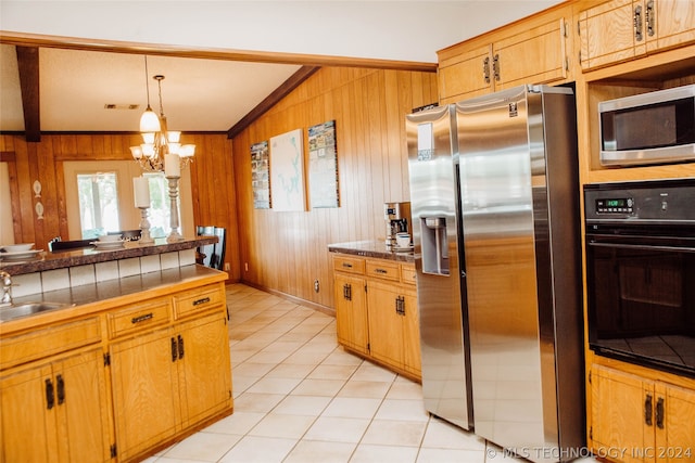 kitchen with stainless steel appliances, wood walls, vaulted ceiling with beams, and pendant lighting