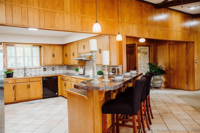 kitchen featuring dishwasher, light colored carpet, hanging light fixtures, decorative backsplash, and sink