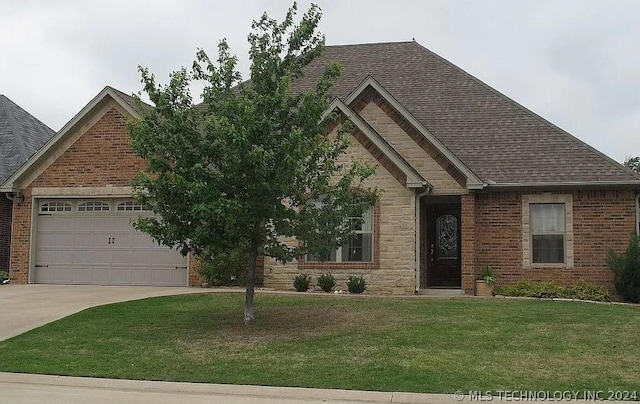 view of front of home featuring a garage and a front lawn