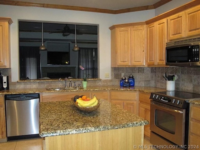 kitchen featuring sink, stainless steel appliances, kitchen peninsula, stone countertops, and decorative backsplash