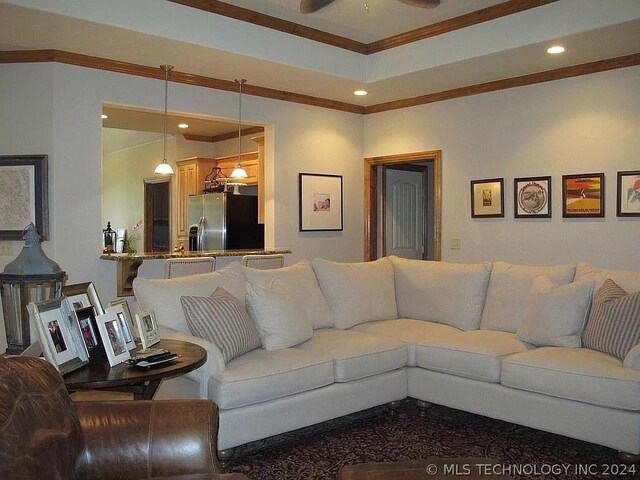 living room with ceiling fan and ornamental molding