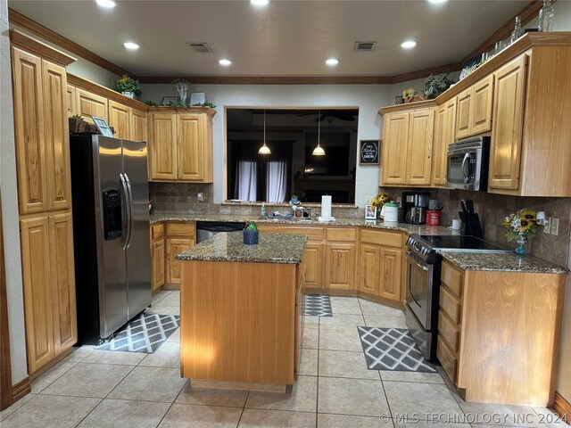 kitchen featuring backsplash, dark stone countertops, ornamental molding, a kitchen island, and stainless steel appliances