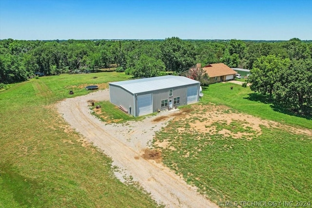 drone / aerial view with a wooded view