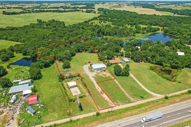 birds eye view of property with a rural view and a water view