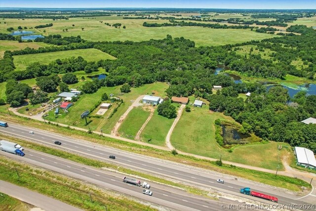 birds eye view of property with a rural view and a water view