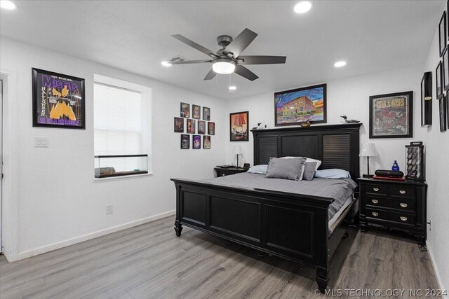 bedroom with a ceiling fan, recessed lighting, baseboards, and wood finished floors