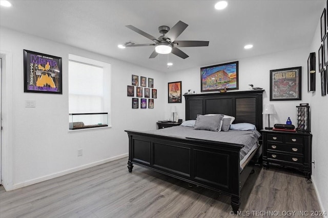 bedroom featuring a ceiling fan, recessed lighting, wood finished floors, and baseboards