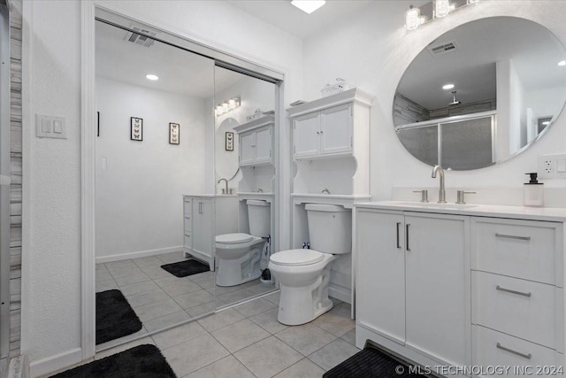 bathroom featuring vanity, visible vents, a stall shower, tile patterned floors, and toilet
