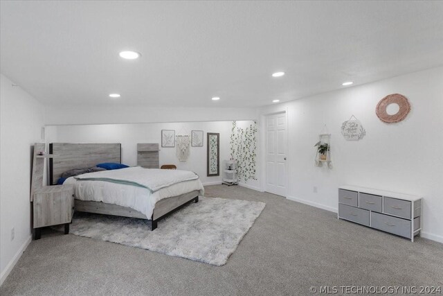 bedroom featuring recessed lighting, light colored carpet, and baseboards