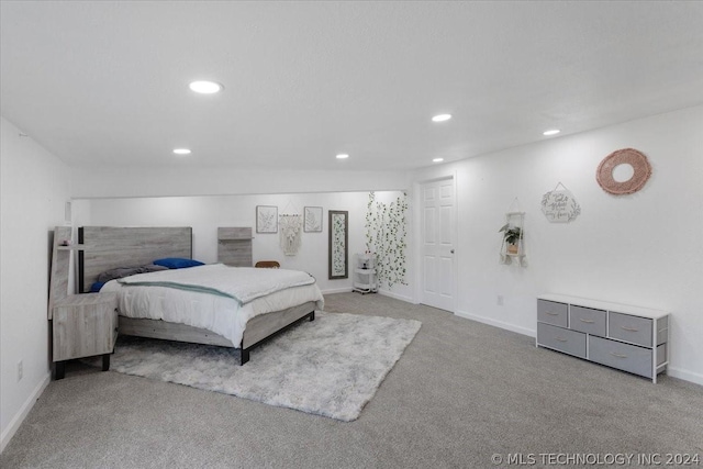 carpeted bedroom featuring recessed lighting and baseboards