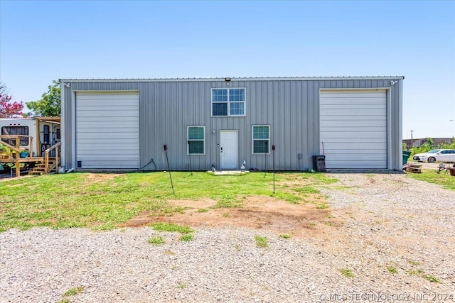 rear view of property featuring board and batten siding and an outdoor structure