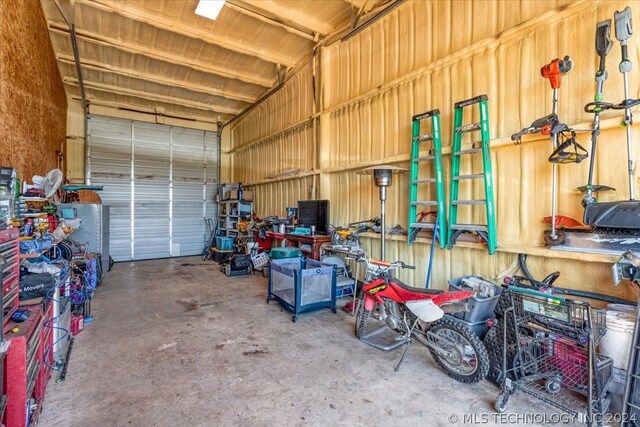 garage with a workshop area and metal wall