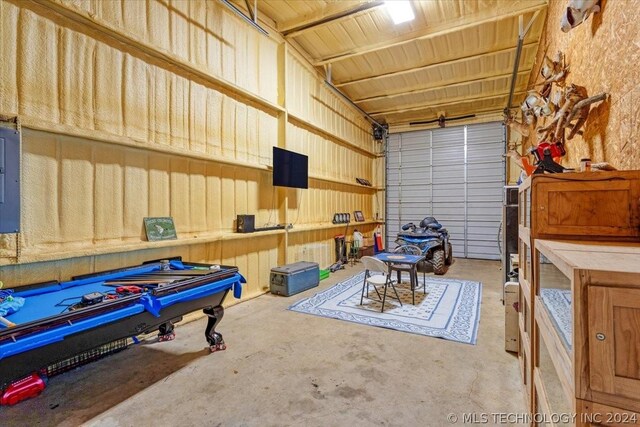 garage with metal wall and electric panel