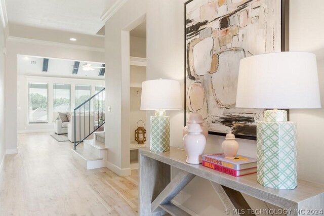 interior space with crown molding and light hardwood / wood-style flooring