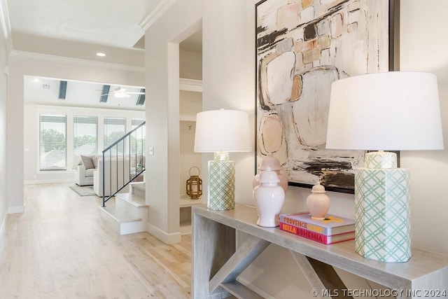 interior details featuring crown molding, baseboards, and wood finished floors