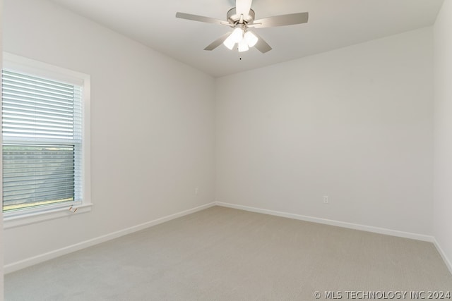 empty room featuring ceiling fan and carpet floors