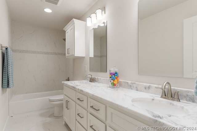 full bathroom featuring toilet, tiled shower / bath combo, and vanity