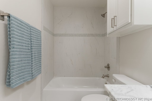 full bathroom featuring vanity, toilet, and tiled shower / bath combo