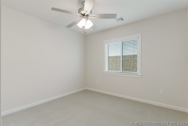 carpeted empty room featuring ceiling fan