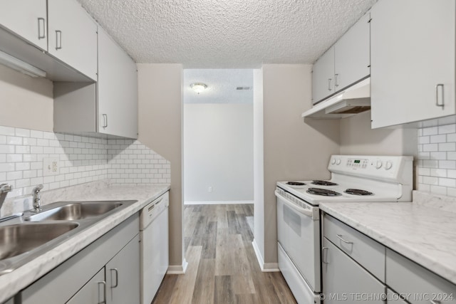 kitchen featuring white cabinetry, white appliances, tasteful backsplash, and a textured ceiling