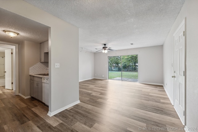 unfurnished living room with ceiling fan, a textured ceiling, and light hardwood / wood-style floors