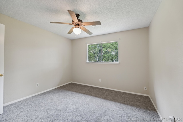 empty room with ceiling fan, carpet, and a textured ceiling