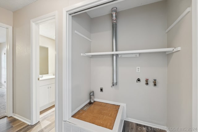 laundry room with gas dryer hookup, washer hookup, wood-type flooring, and hookup for an electric dryer