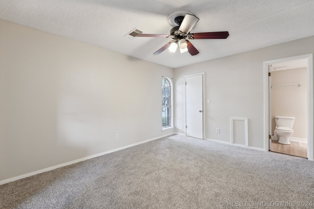 unfurnished bedroom featuring connected bathroom, carpet flooring, ceiling fan, a textured ceiling, and a closet