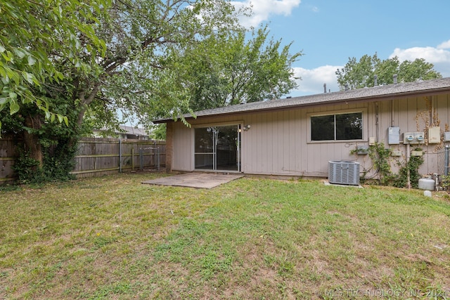 back of house with a patio area, central AC unit, and a lawn