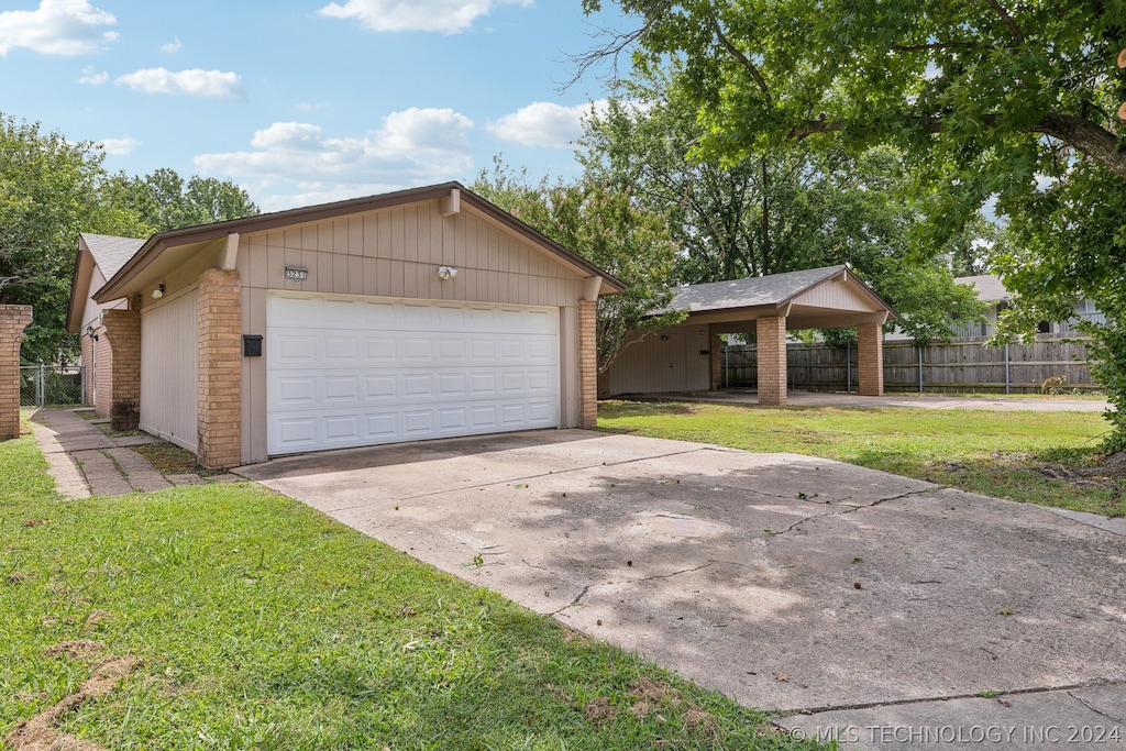 exterior space featuring a carport and a yard