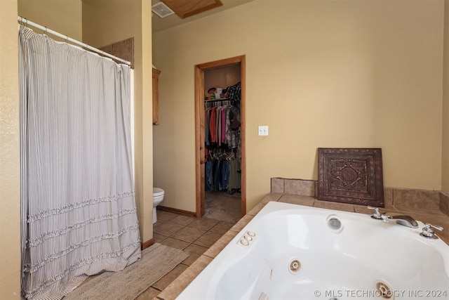 bathroom with a bathtub, tile patterned floors, and toilet