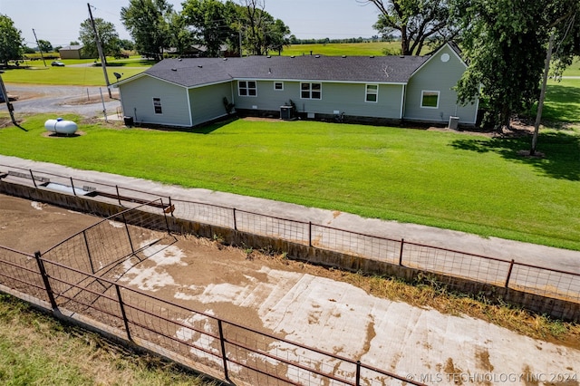 back of property featuring a lawn