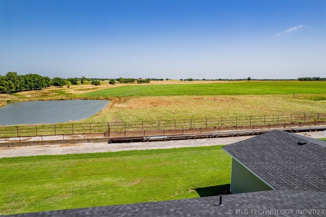 view of yard with a water view and a rural view