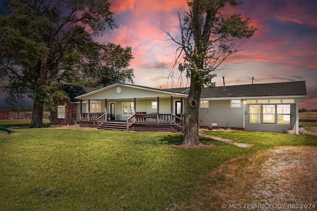 view of front of home with a yard and covered porch