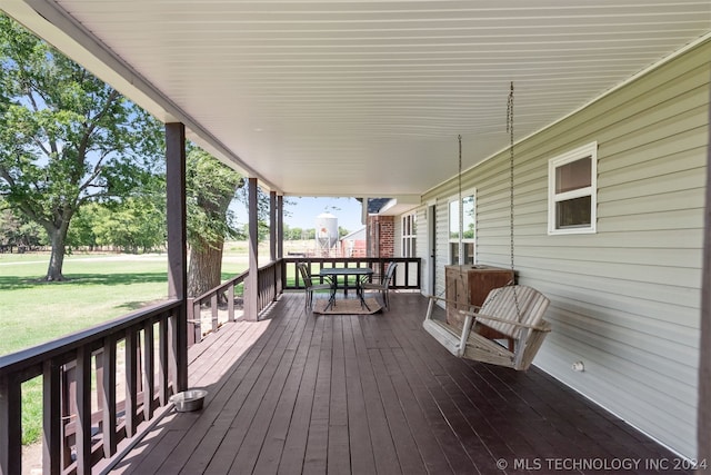 deck featuring a yard and covered porch