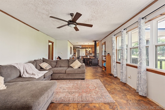 living room with ceiling fan with notable chandelier and a textured ceiling