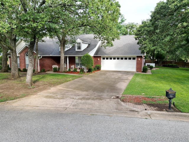 view of front of home with a garage and a front lawn