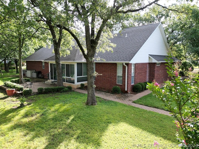 view of front of house with a front lawn and a patio