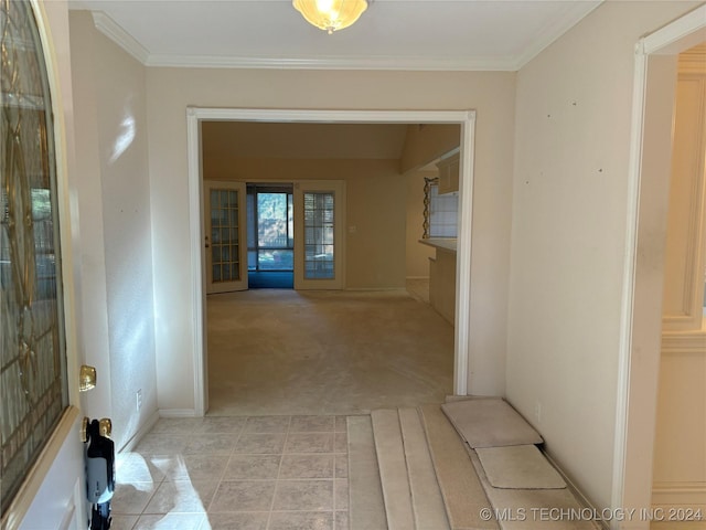 corridor with crown molding and light colored carpet