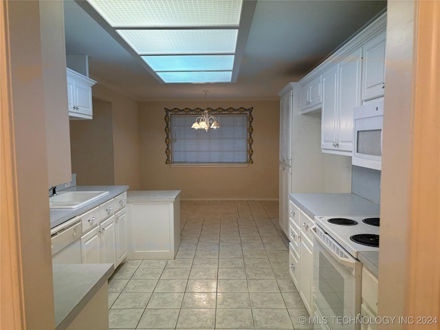 kitchen with white cabinetry, sink, pendant lighting, and white appliances