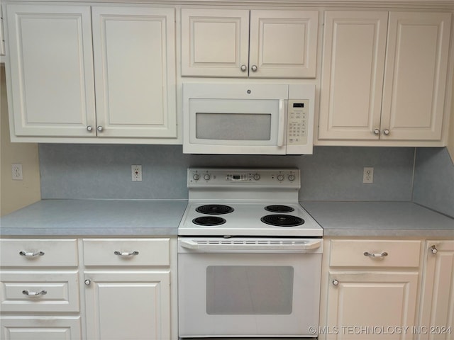 kitchen featuring white appliances and white cabinets