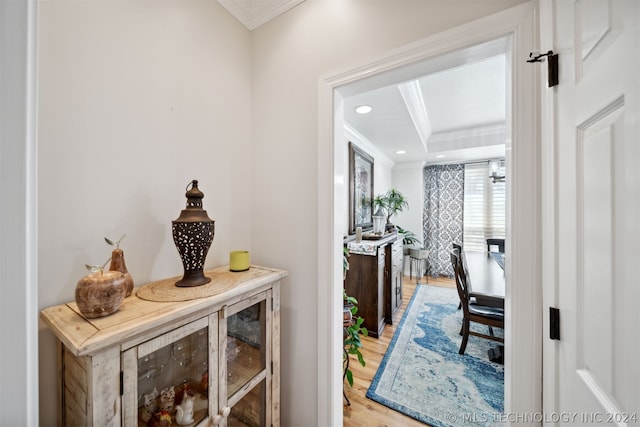 hall featuring ornamental molding and hardwood / wood-style floors