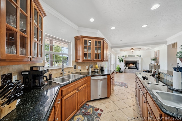 kitchen with sink, ornamental molding, light tile patterned floors, tasteful backsplash, and stainless steel dishwasher