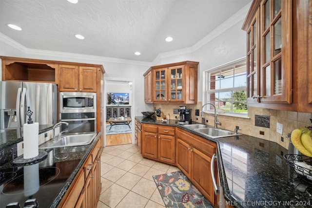 kitchen featuring stainless steel appliances, light tile patterned flooring, sink, and crown molding